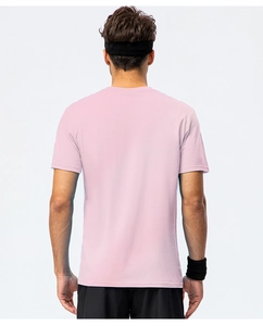Rear view of pink cotton T-shirt on male model with athletic headband and wristbands