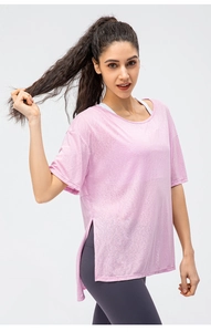 Detail of pink loose fit sports t-shirt showing side slit and breathable mesh fabric