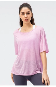 Detailed texture of breathable pink sports top with sheer fabric and seamless mesh