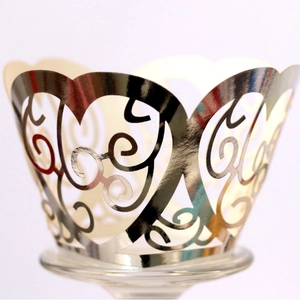 Silver laser-cut heart cupcake wrappers with elegant scroll patterns for party decor