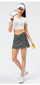 Detail of high-waisted crossover waistband and side slit on grey tennis skort