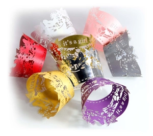 Detailed laser cut flower pattern and it's a girl text on colorful cupcake wrappers