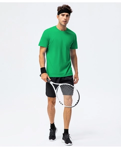 Athletic man wearing a vibrant green crew neck cotton t-shirt and black sports shorts