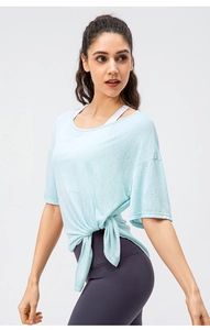 Detail of light blue yoga tee featuring a stylish side-knot design and breathable fabric
