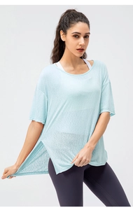 Detail of light blue breathable yoga top with side slits and loose fit for sports