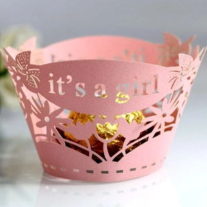 Pink laser cut cupcake wrapper with It's a Girl cutout for baby shower decorations
