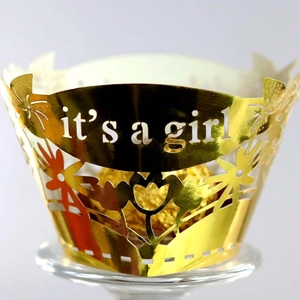 Golden hollow cupcake wrapper with It's a Girl laser cut text for baby shower parties