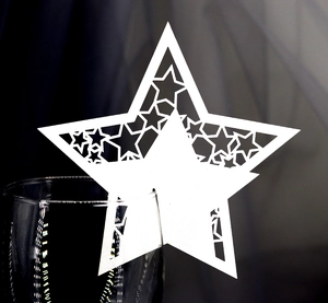 Laser-cut white star-shaped wine glass card with intricate hollow pattern for wedding decor