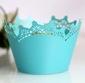 Macro view of laser-cut crown lace cupcake wrappers in elegant tiffany blue pearlescent paper