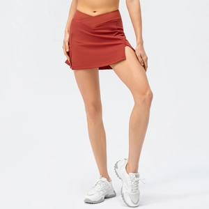 Rust red high waist tennis skirt with side slit and built-in shorts for fitness