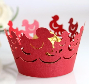 Close-up of laser-cut dark purple cupcake wrappers featuring elegant duck pattern