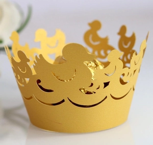 Detail of yellow laser-cut duck cupcake wrapper with smooth matte paper texture