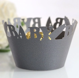 Detail showing laser-cut BABY lettering on dark grey pearl paper cupcake wrapper