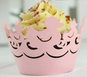 Close-up of pink laser-cut cupcake wrappers with cute duck patterns for parties