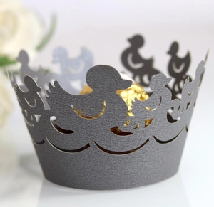 Close-up of laser-cut duck pattern cupcake wrappers with sparkling texture for party