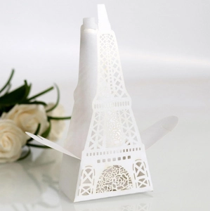 Detailed laser-cut white Eiffel Tower candy box with rose patterns for wedding favors