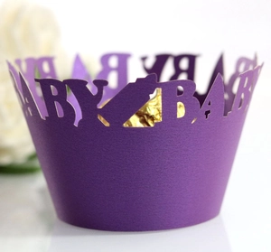Purple laser-cut baby bottle cupcake wrappers with hollow baby text for parties
