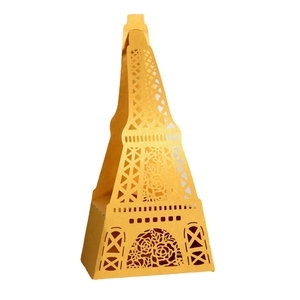 Detailed laser-cut floral patterns and Eiffel Tower design on a golden party favor box