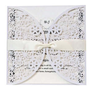 Laser-cut floral wedding invitation set with white hollow sleeve and satin ribbon bow