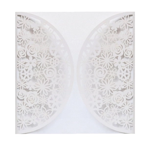 Elegant white laser-cut wedding invitation featuring intricate floral patterns on premium paper