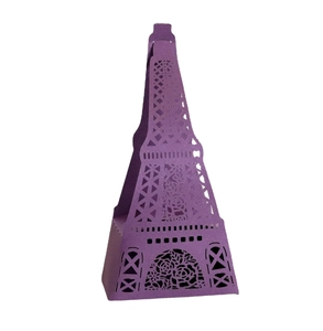 Detail of laser-cut Eiffel Tower favor box with purple floral hollowed pattern