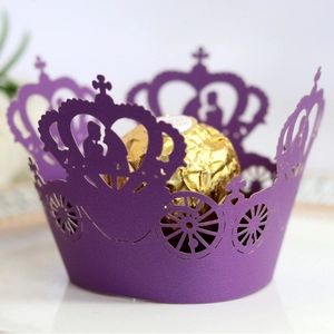 Laser-cut purple wedding cupcake wrappers with crown and carriage motifs on pearl paper