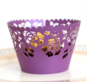 Close-up of purple laser-cut lace cupcake wrappers with elegant rose patterns