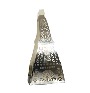 Macro detail of silver laser-cut Eiffel Tower candy box with intricate floral hollow patterns