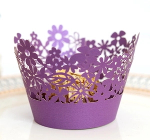 Detailed laser-cut purple cupcake wrapper with intricate floral patterns for party decor