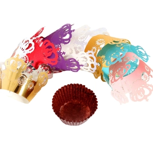 Laser cut paper cupcake liners with royal carriage and crown designs in assorted colors
