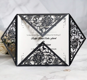 Elegant laser-cut floral wedding invitation with black hollow cover and white inner card