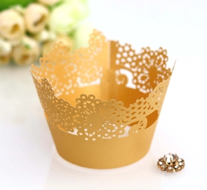 Elegant gold laser-cut lace cupcake wrappers with delicate floral hollow design for parties