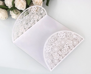 Elegant white laser cut wedding invitation covers with intricate floral rose patterns