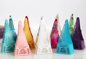 Macro detail of laser-cut paper candy boxes in various colors with Eiffel Tower design