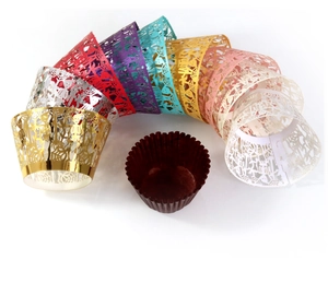 Laser cut Halloween cupcake wrappers set with skull and spider web designs in multi-colors