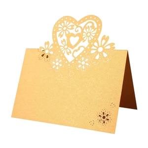 Detailed laser-cut heart and floral design on champagne gold pearlescent table card