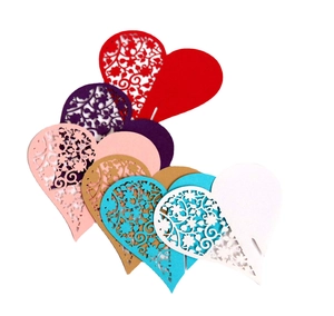 Laser-cut heart-shaped paper place cards with hollow floral patterns for wine glass decor