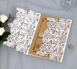 Detailed laser-cut floral wedding invitation with white hollow sleeve and kraft inner card