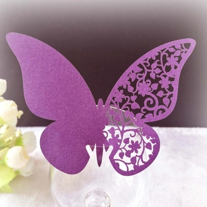 Elegant purple pearlescent butterfly place card with intricate laser-cut lace floral pattern