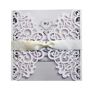 Laser cut navy blue wedding invitation with pink glitter card and white satin ribbon bow