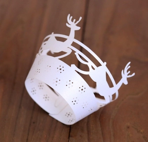 Macro view of laser-cut Christmas reindeer paper cupcake wrappers in white finish