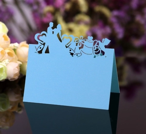 Detailed laser-cut wedding name card featuring romantic bride and groom silhouettes