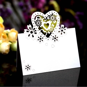Elegant white laser-cut hollow heart table place cards for wedding party decor