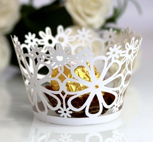 Elegant white laser-cut floral cupcake wrapper with daisy pattern for wedding favors