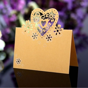 Elegant laser cut heart and flower place cards in yellow for wedding table decorations