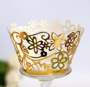 Elegant gold laser-cut floral cupcake wrappers for weddings and festive party decorations
