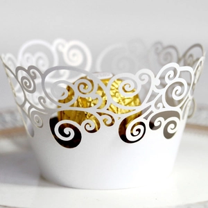 Laser-cut white cupcake wrapper with elegant scroll pattern and chocolate placement