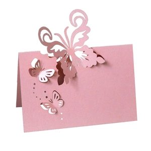 Detail view of pink laser-cut 3D butterfly place cards with pearlescent finish