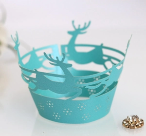 Detailed laser-cut Christmas reindeer design on teal blue lace cupcake wrappers