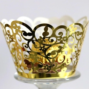 Elegant gold laser-cut cupcake wrappers with intricate floral patterns for party decor
